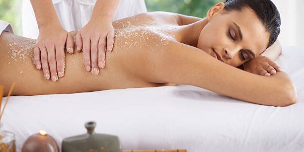 Shot of a young woman enjoying a massage at a spa
